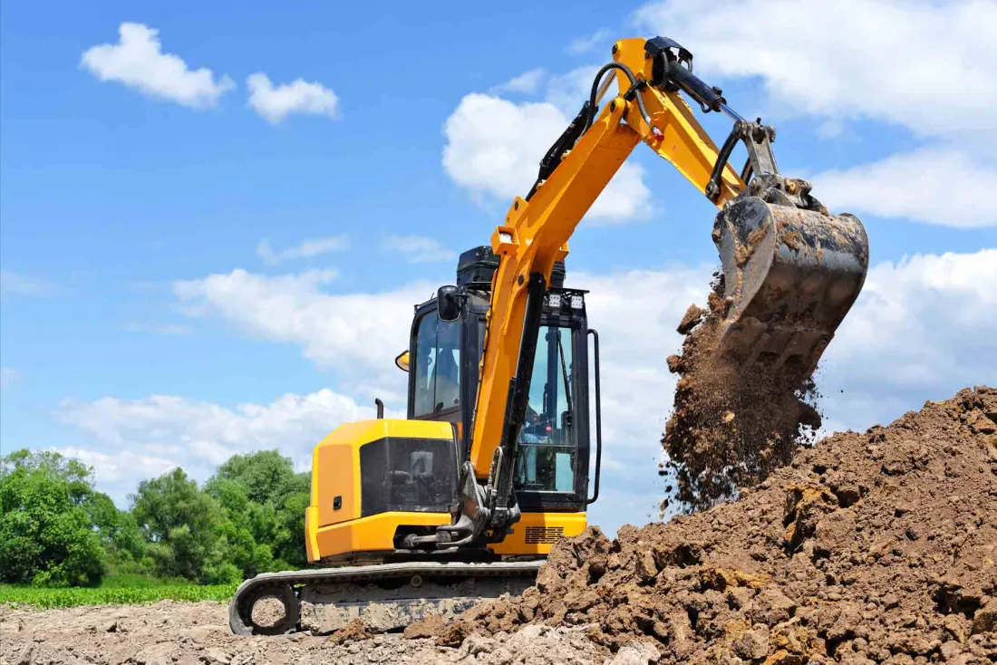 Excavator digging and moving earth on a site in Spring, TX